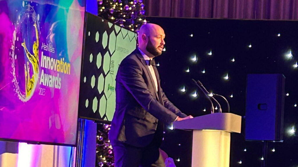 Presenting at the lectern at the MediWales Innovation Awards 2023